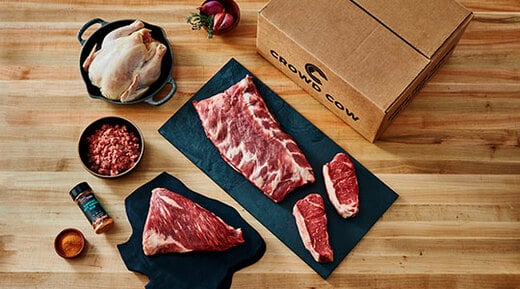 Crowd cow meats set on wood surface